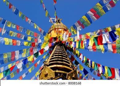 nepalese stupa with colorful prayer flags and clear blue sky