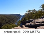 The Nepean Gorge, view from the rock lookout and surrounding area. Lush eucalyptus bush land and river running through the valley on a sunny blue sky day.