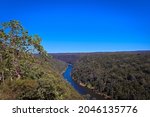 The Nepean Gorge, view from the rock lookout and surrounding area. Lush eucalyptus bush land and river running through the valley on a sunny blue sky day.