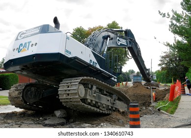 Nepean, Ontario, Canada - August 18, 2006: Tilting Caterpillar Excavator On Suburban Residential Sewer Project