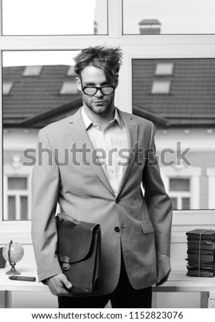 Nerd or brainiac wearing classic jacket. Academic style and business concept. Serious man or professor with bristle in nerd glasses. Man with briefcase isolated on white background.