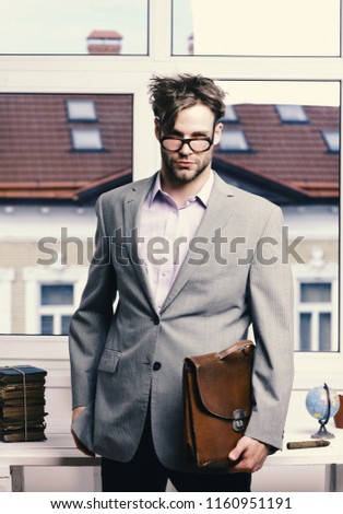 Nerd or brainiac wearing classic jacket. Academic style and business concept. Serious man or professor with bristle in nerd glasses. Man with briefcase isolated on white background.
