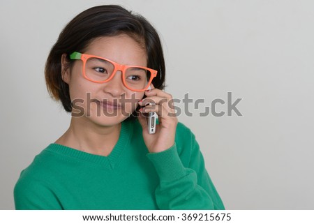 Nerd girl talking on mobile phone