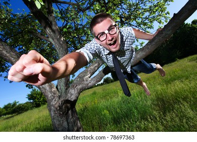 Nerd Man Thinking That He Is Superhero On The Tree