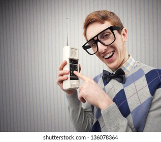 Nerd student with an old mobile phone
