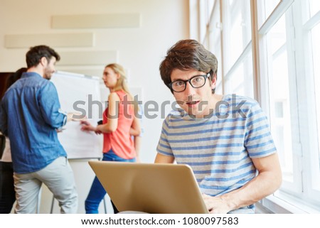 Nerd student programmer with laptop sorprised 