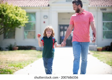 Nerd With Teacher Hold Apple. Education. First Day At School. Father And Son Come Back From School