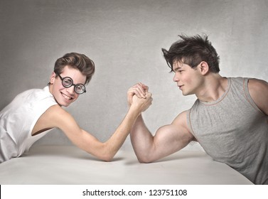 Nerd is wrestling with a muscular guy