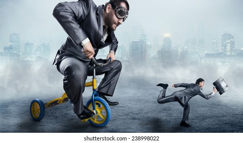 Nerdy businessman riding a small bicycle