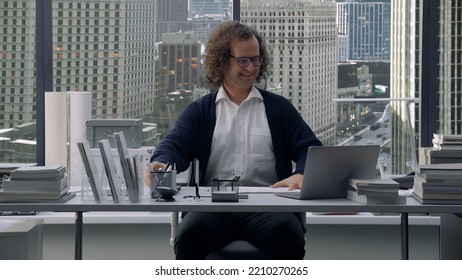 Nerdy Looking Manager Enjoying Promotion, Sitting At His New Working Desk