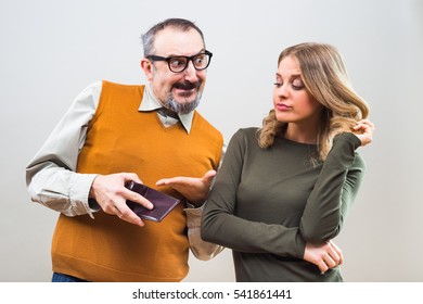 Nerdy Man Is Trying To Get Attention From A Beautiful Woman By Showing Her His Wallet Full Of Money But She Is Still Not Interested.Nerdy Man Trying To Impress Woman With His Wealth
