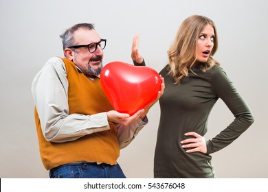 Nerdy Man Wants To Give Heart Shape Balloon To A Beautiful Woman To Show Her His Love,but She Is Not Interested.Unrequited Love
