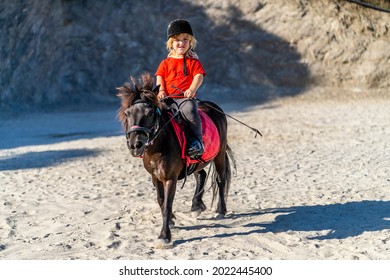 Nerja, Spain - July 14, 2021: Dwarf Girl Anika Brilliantly Riding Pony Horse