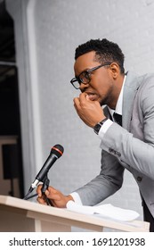 Nervous African American Speaker Biting Nails During Business Conference In Office