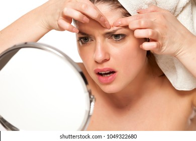 Nervous Beautiful Woman With Towel On Hr Head On White Background Squeeze Pimples On Her Face