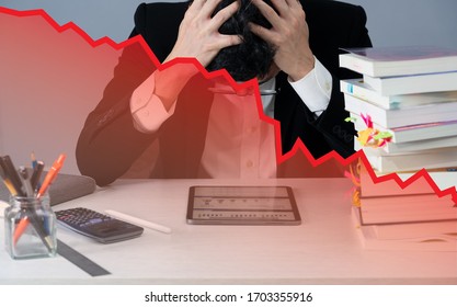a nervous business man in desk when business crash with red stock price chart plummet, slow growth economy