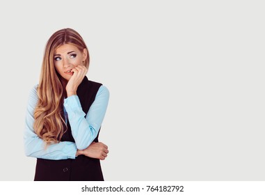 Nervous. Closeup Portrait Head Shot Stressed Young Woman Girl Employee Student Biting Fingernails Looking Anxiously Craving Something Over Light Grey Background. Human Emotion Face Expression Feeling