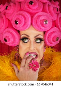 Nervous Drag Queen In Pink Wig Biting Nails