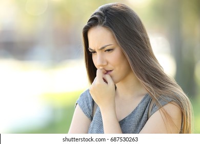 Nervous Girl Biting Nails Outside In The Street