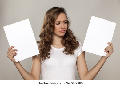 Nervous Girl Holding Two Blank Sheets Of Paper