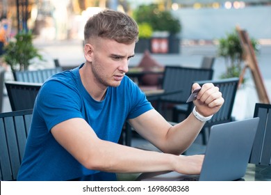 Nervous Horrified Confused Young Man, Stressed Worried Guy Having Problem With Paying, Buying Online, Payments With Credit Blocked Bank Card, Looking At Screen, Monitor Of Laptop. Internet Fraud