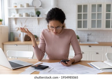 Nervous latina woman bookkeeper freelancer annoyed with debt mistake in financial document. Worried anxious lady mobile bank client unable to pay bills online dissatisfied with bad work of app service