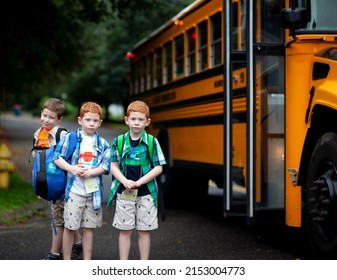 Nervous Looking Twin Brothers Waiting To Board School Bus On Their First Day Of School