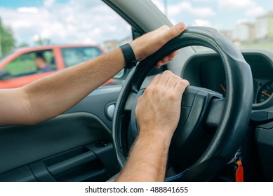 Nervous Male Driver Pushing Car Horn In Traffic Rush Hour, Close Up With Selective Focus On Hand On The Steering Wheel