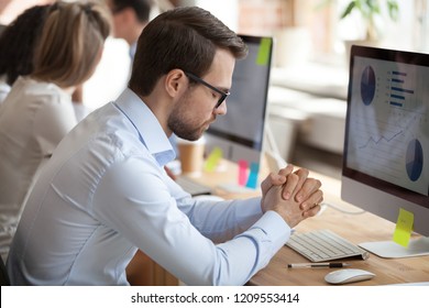 Nervous Male Millennial Worker Working At Computer In Shared Office, Trying Keep Calm Not Pay Attention To Problems, Worried Employee Meditate At Workplace Staying Patient, Controlling Emotions