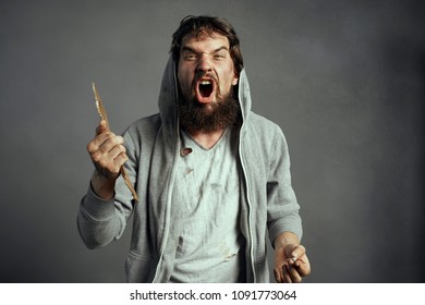 Nervous Man In A Tattered Shirt And With A Cardboard In His Hand                              