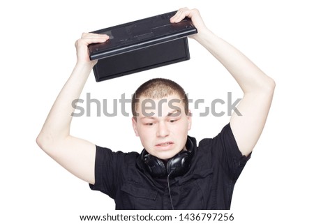 Nervous manager in black breaks a laptop