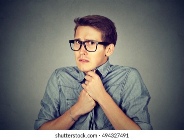 Nervous Stressed Young Man Student Feels Awkward Looking At Camera Anxiously Craving Something Isolated Gray Wall Background. Human Emotion Face Expression Feeling Body Language