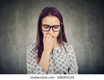 Nervous Woman Biting Nails And Looking Down Feeling Insecure 