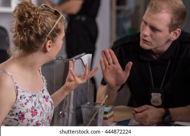 Nervous Woman At A Police Station And Policeman Trying To Calm Her Down