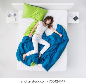 Nervous Woman Sleeping And Dreaming On A Messy Bed, Restless Sleep And Sleep Disorders Concept, Top View