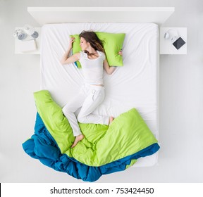 Nervous Woman Sleeping And Dreaming On A Messy Bed, Restless Sleep And Sleep Disorders Concept, Top View