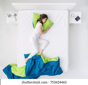 Nervous Woman Sleeping And Dreaming On A Messy Bed, Restless Sleep And Sleep Disorders Concept, Top View