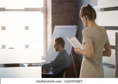 Nervous Worker Holding Handouts Worried Before Entering Meeting Room, Making Presentation For Colleagues, Frustrated Woman Employee Scared Join Team Meeting In Conference Area. Public Speaking Fear