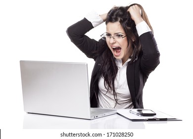 nervous young business woman at the desk with a laptop chip her hair and screaming