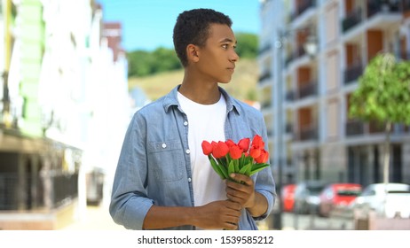 Nervous Young Male With Tulips Bouquet Waiting For Girl On Street, First Date