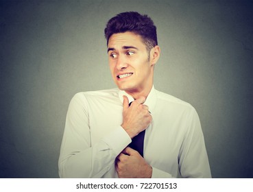 Nervous Young Man Feels Awkward Looking Away Anxiously Isolated On Gray Background. 