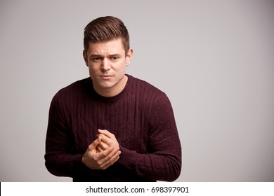 Nervous Young White Man Rubbing His Hands Looking Away