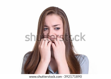 Nervous young woman biting her nails 