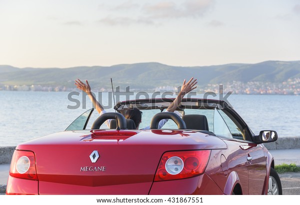NESSEBAR, BULGARIA - APRIL 30: Woman in the car\
Renault Megane Coupe Cabrio on the waterfront on April 30, 2016 in\
Nessebar, Bulgaria.