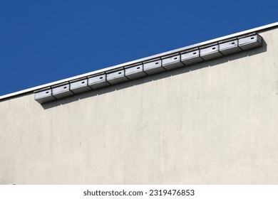 Nest boxes for  Swifts ( Apus apus ) hung on the wall of an apartment building, tongues fight mosquitoes and other insects, ecological and natural methods of combating nuisance insects in the city