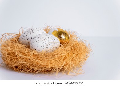 Nest with Easter eggs on white table. Selective focus.