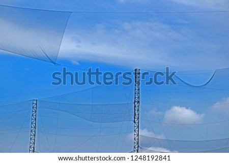 Similar – wooden platform with blue posts with ropes and orange lifebuoys on the background of the sea and sky with clouds Egypt Dahab South Sinai