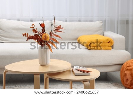Nesting tables and comfortable sofa in living room. Interior design