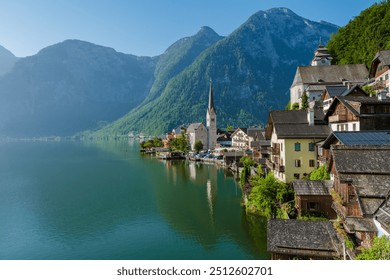 Nestled between majestic mountains, Hallstatt showcases picturesque houses lining the tranquil lake, reflecting the beauty of nature - Powered by Shutterstock