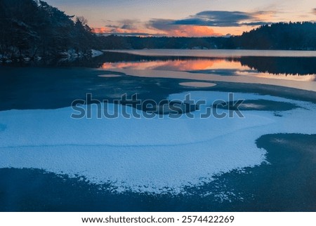 Similar – Image, Stock Photo Partly frozen lake with a view of the snow-covered fir forest